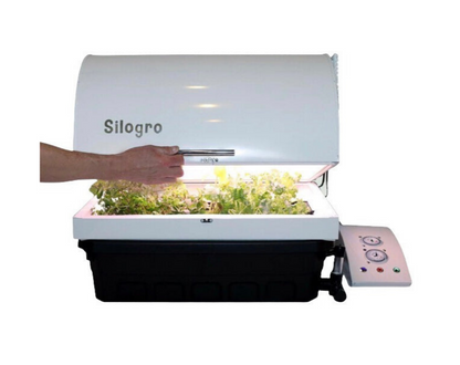 A hand opening the Silogro Indoor Grow Box.